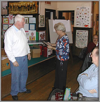 Martin presents Janet with an award